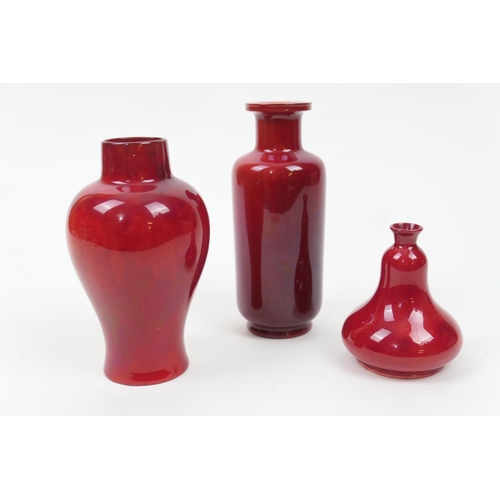 99 - Three Bernard Moore red flambe small vases, comprising a small pear shaped vase, impressed shape no.... 