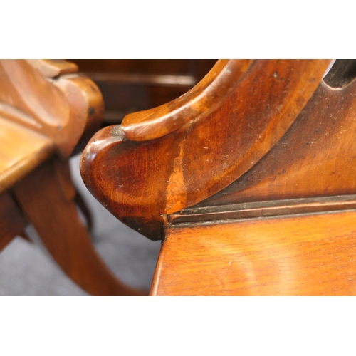 927 - Pair of Victorian mahogany hall chairs, circa 1860, carved backs centred with a scallop shell, over ... 