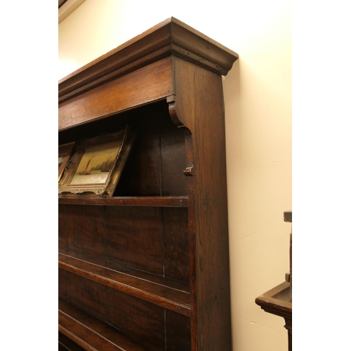 922 - George III oak dresser and plate rack, circa 1800-20, the boarded rack with three shelves over an en... 