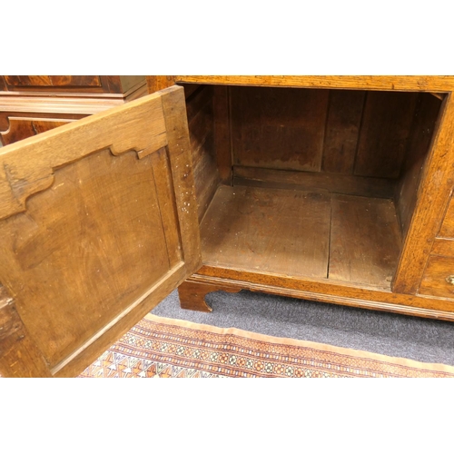 922 - George III oak dresser and plate rack, circa 1800-20, the boarded rack with three shelves over an en... 