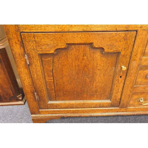 922 - George III oak dresser and plate rack, circa 1800-20, the boarded rack with three shelves over an en... 