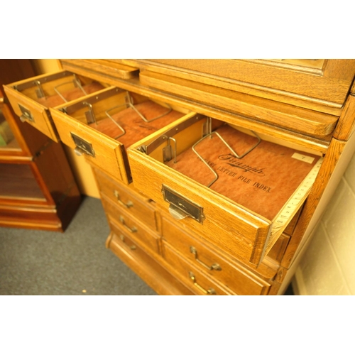 956 - Oak sectional bookcase in Globe Wernicke style, having a three section bookcase top with up and over... 