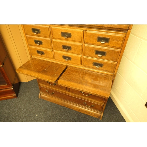 956 - Oak sectional bookcase in Globe Wernicke style, having a three section bookcase top with up and over... 