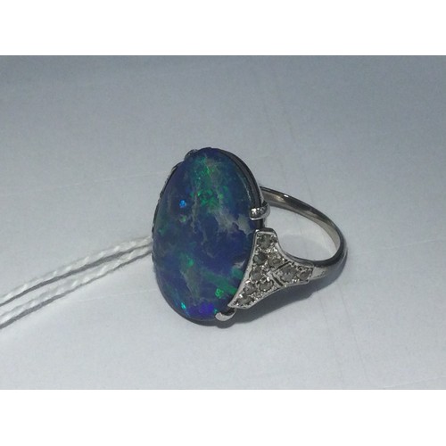 338 - Black opal and diamond ring, having a cabochon opal doublet of approx. 20mm x 16mm, the shoulders se... 