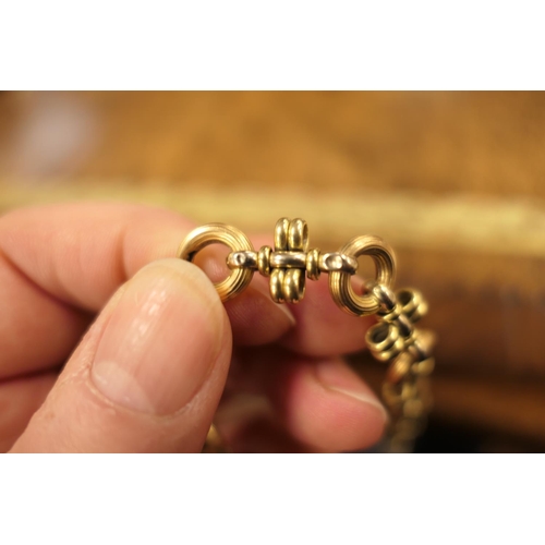 390 - 18ct gold circular and cross bar link bracelet, with large ring clasp, length 21cm, weight approx. 1... 