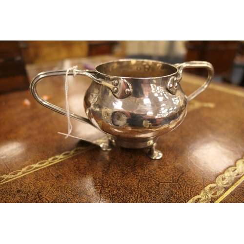 135 - Arts and Crafts silver composite three piece tea service, the lidded hammered teapot by William Hutt... 