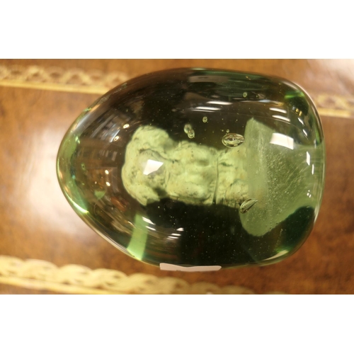 84 - Unusual Victorian green glass dump, encasing a spaniel, 10cm; also another encasing a flower, height... 