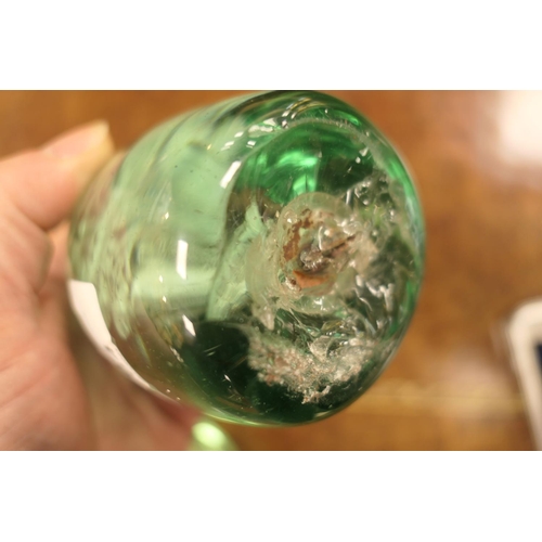 84 - Unusual Victorian green glass dump, encasing a spaniel, 10cm; also another encasing a flower, height... 