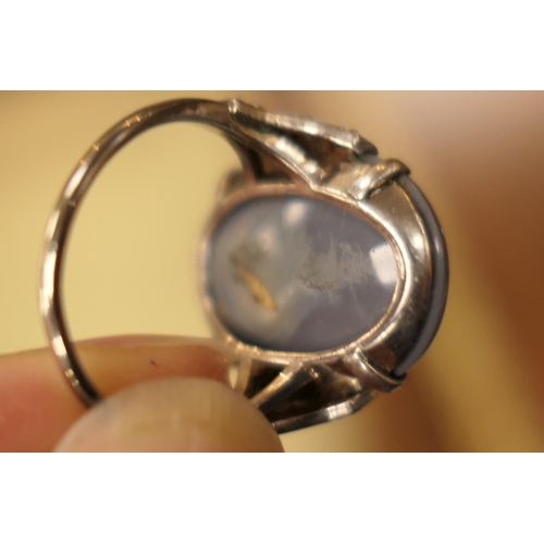 338 - Black opal and diamond ring, having a cabochon opal doublet of approx. 20mm x 16mm, the shoulders se... 