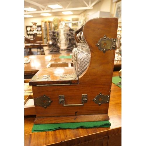 698 - Victorian walnut and brass mounted tantalus, circa 1850-70, having three wrythen moulded glass squar... 