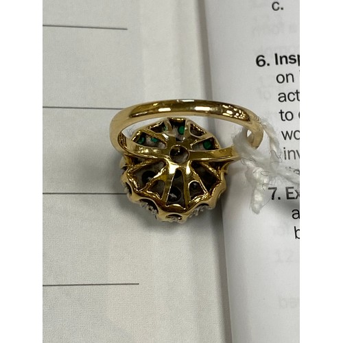 396 - Unusual diamond and emerald cluster ring, centred with seven round cut diamonds totalling approx. 1.... 