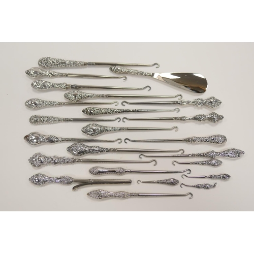 336 - Twenty-one assorted silver handled button hooks; also a silver handled glove stretcher and shoe horn... 