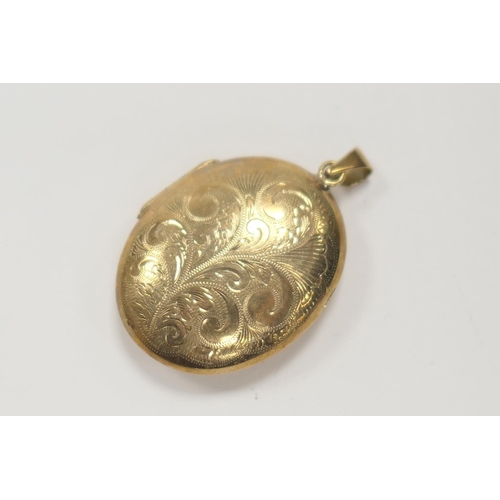 409 - 9ct gold foliate engraved oval picture locket with suspension loop, locket length 36mm, gross weight... 