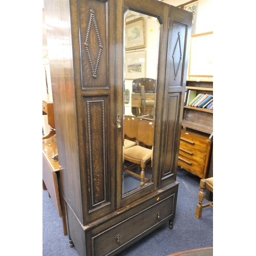 523 - Jacobean Revival oak bedroom suite comprising mirrored wardrobe, dressing chest and chest of drawers