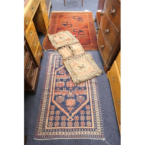 536 - Middle Eastern woollen saddlebag; also a Turkish red ground woollen rug and a further Eastern blue g... 