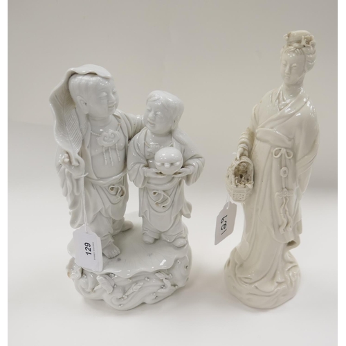 129 - Chinese blanc de chine figure group, height 23.5cm; also a blanc de chine figure of a woman holding ... 