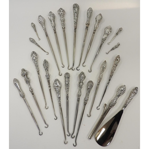 250 - Twenty-one assorted silver handled button hooks; also a silver handled glove stretcher and shoe horn... 