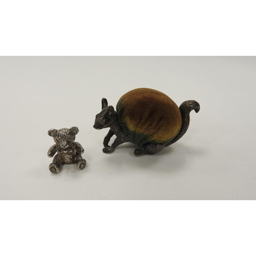 242 - Unusual squirrel form pin cushion, the carved body marked silver, 6.5cm; also a modern silver teddy ... 