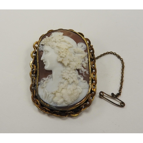 248 - Italian carved cameo brooch featuring a bacchante with gold plated gold chain form mount, 5.5cm