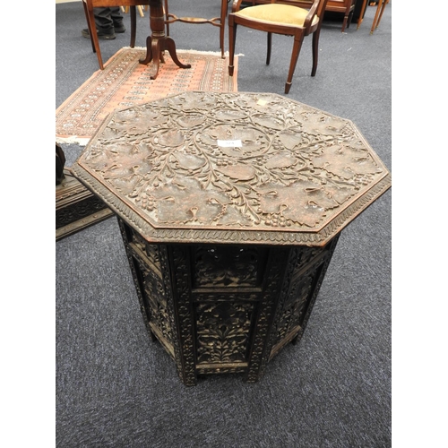 324 - Indian carved wooden octagonal table, profusely carved with vine leaves, height 49cm