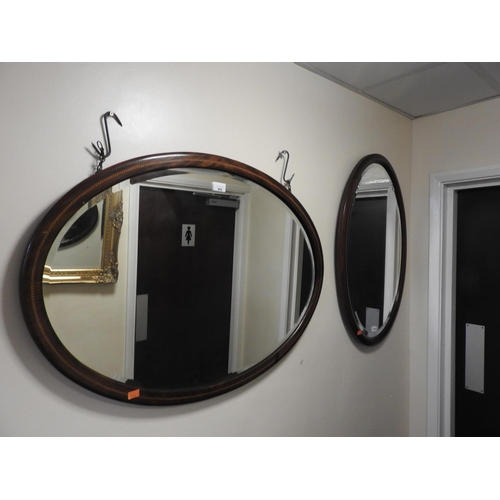 460 - Edwardian mahogany and inlaid oval wall mirror, 89cm x 64cm, and a further mahogany oval wall mirror... 