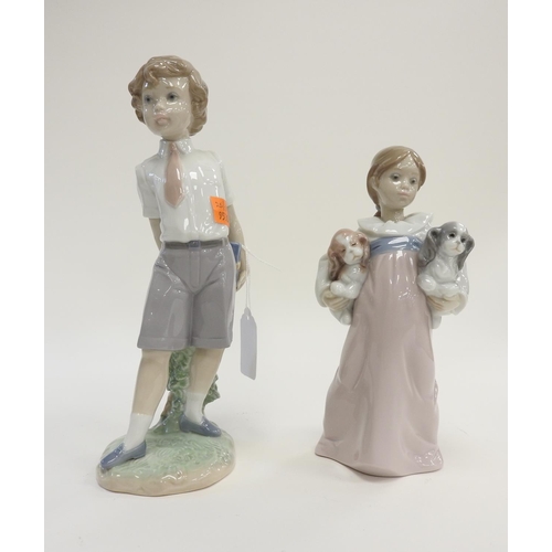 122 - Lladro porcelain figure of a school boy, and a Lladro figure of a girl with puppies (2)