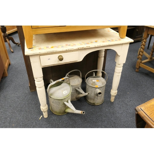 448 - Three galvanised watering cans and a Victorian white painted kneehole table (4)