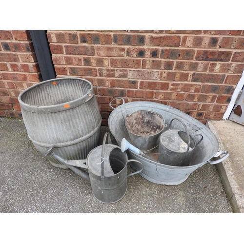 503 - Number of galvanised items including traditional dolly tub, oval wash tub, two watering cans and a p... 