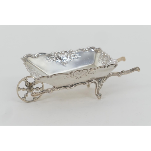 104 - Continental white metal novelty sweetmeat dish, formed as a wheelbarrow, solid sides with repousse d... 