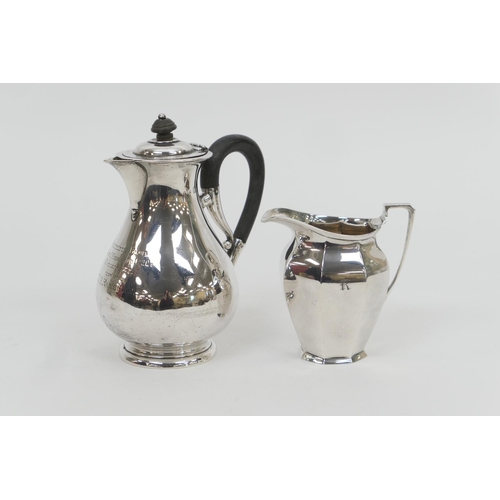 131 - Late Victorian silver hot water jug, London 1899, baluster form and with presentation inscription da... 