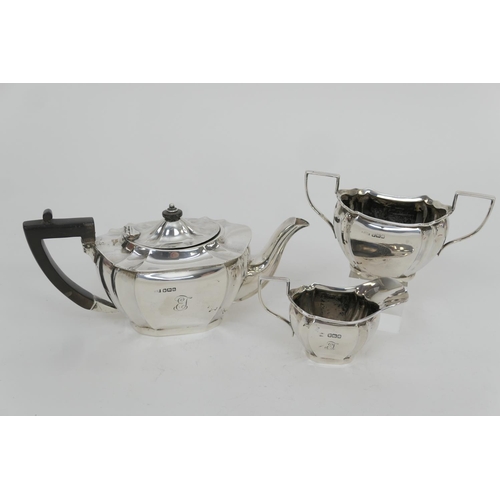 139 - George V silver three piece tea service, Sheffield 1917, comprising a fluted canted teapot, with ebo... 