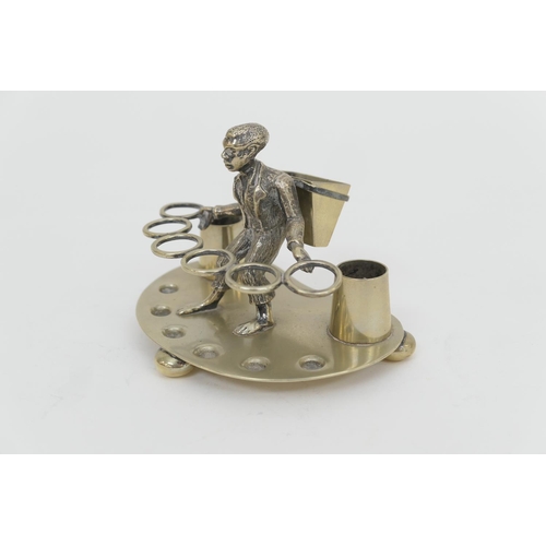 141 - Unusual electroplated pipe stand, late 19th Century, centred with a tobacco leaf picker, width 13cm