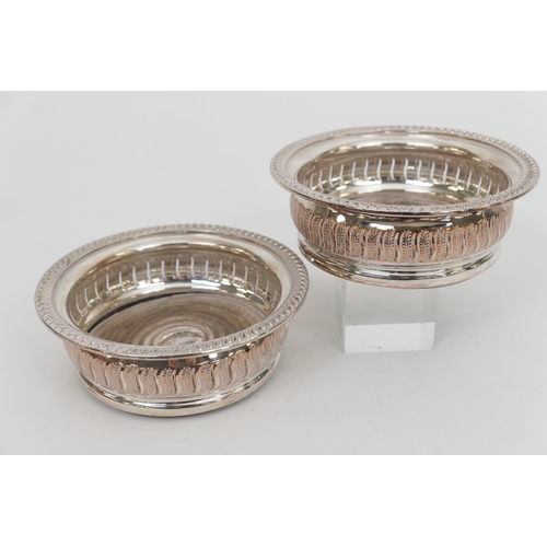 142 - Pair of silver plated wine coasters, 19th Century, turned wooden base, 14.5cm diameter