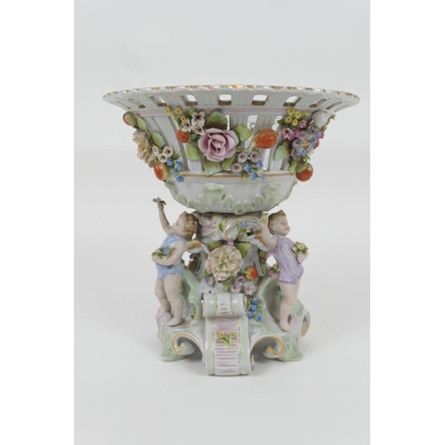 33 - Plaue porcelain table centre, the central circular basket supported on a base encrusted with flowers... 
