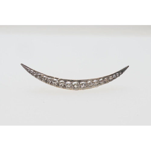 390 - Diamond crescent brooch, set with nineteen old round cut diamonds, the largest centre stone of appro... 