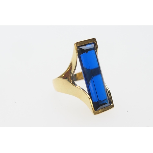 426 - Continental 18ct gold synthetic sapphire dress ring, long rectangular cut stone in a modernist 18ct ... 