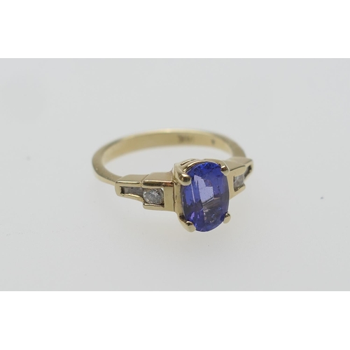 428 - Continental tanzanite and diamond dress ring in 14ct gold, the oval cut tanzanite approx. 9mm x 6mm,... 