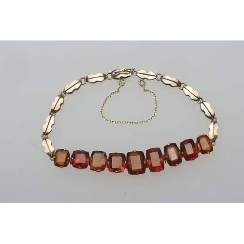 439 - Edwardian gem set bracelet, set with nine amber coloured cushion cut stones (untested), in articulat... 