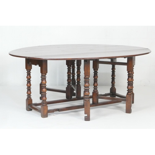 602 - Quality large oak gateleg table in 18th Century style, the oval top with drop leaves supported on do... 