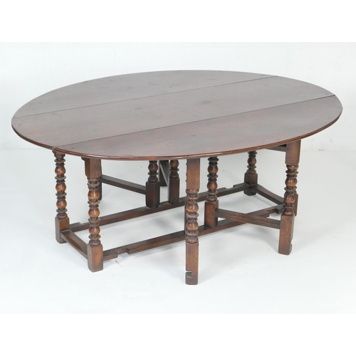 602 - Quality large oak gateleg table in 18th Century style, the oval top with drop leaves supported on do... 