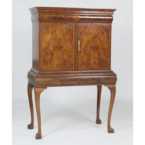 605 - Queen Anne style walnut cabinet on stand, having a moulded cornice with barrel fronted frieze drawer... 