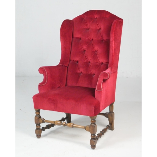 652 - William & Mary style upholstered red fabric upholstered wing armchair, early 20th Century, with turn... 