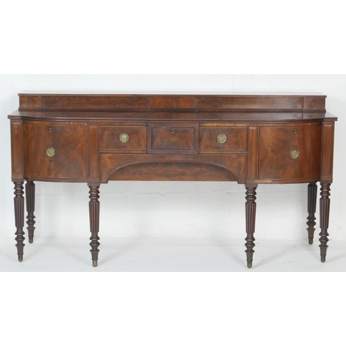 663 - Early Victorian mahogany bowfront sideboard, circa 1840, with a stepped back over a frieze drawer an... 