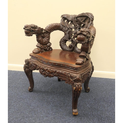 677 - Chinese carved wooden armchair, the back heavily detailed with phoenix, the forearms carved with dra... 