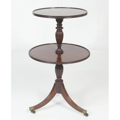 686 - George III mahogany dumb waiter, pedestal form with two circular moulded edge shelves, on a turned a... 