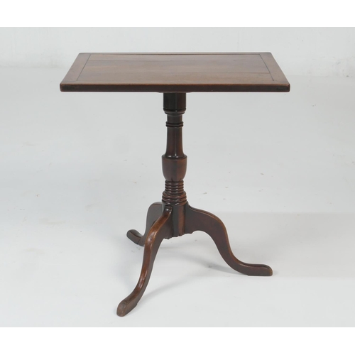 695 - Provincial fruitwood tilt top tripod table, the rectangular top tilting over a turned urn column and... 