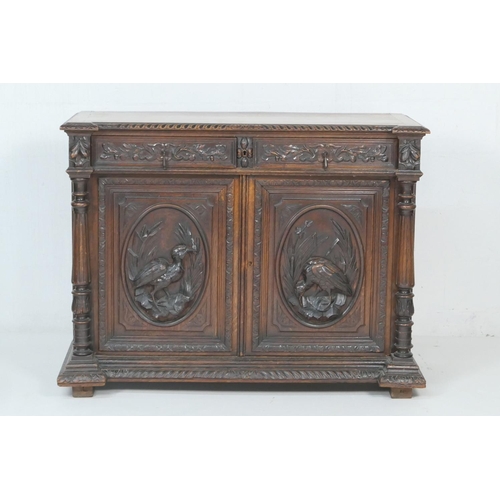 697 - Flemish carved oak side cabinet, late 19th Century, fitted with oak leaf carved frieze drawers with ... 