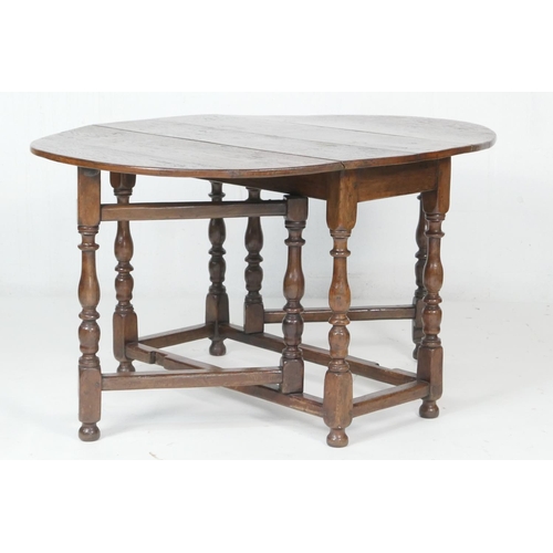 707 - Oak gateleg table, 18th Century with later alterations, oval top with drop leaves, supported on swin... 