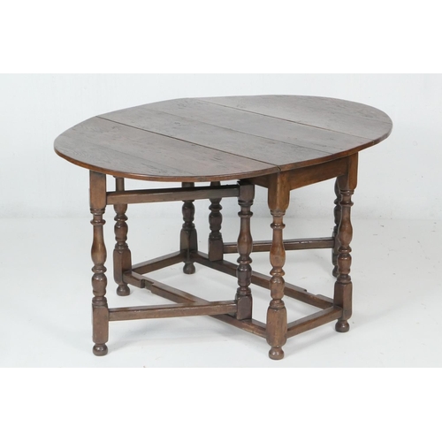 707 - Oak gateleg table, 18th Century with later alterations, oval top with drop leaves, supported on swin... 