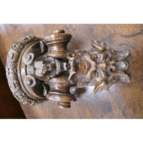 507 - Late 17th Century carved oak bracket, carved with a grotesque mask and paper scroll, 22cm x 16.5cm